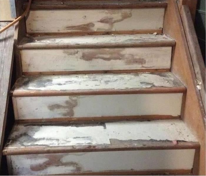 Wood stairs with paint affected by fire and smoke damage